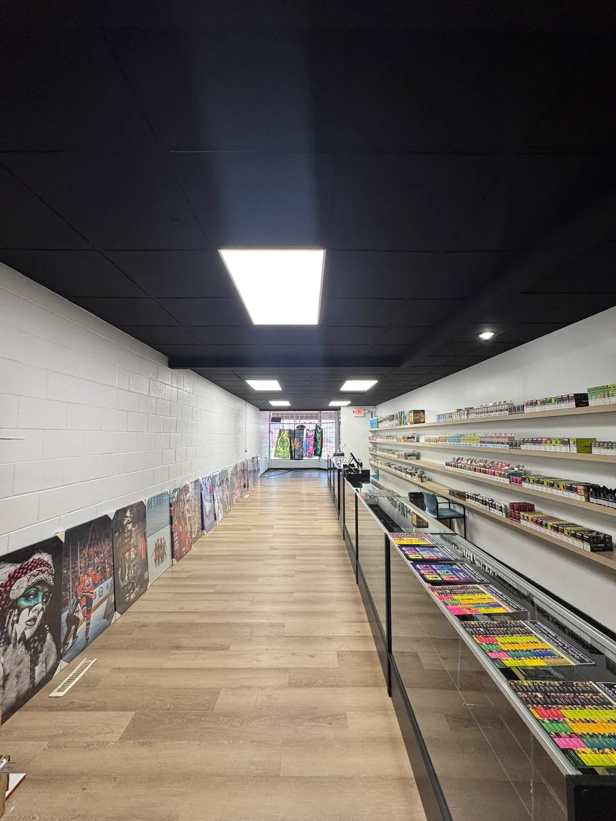 Retail store interior repainted with crisp white walls and a black-painted ceiling